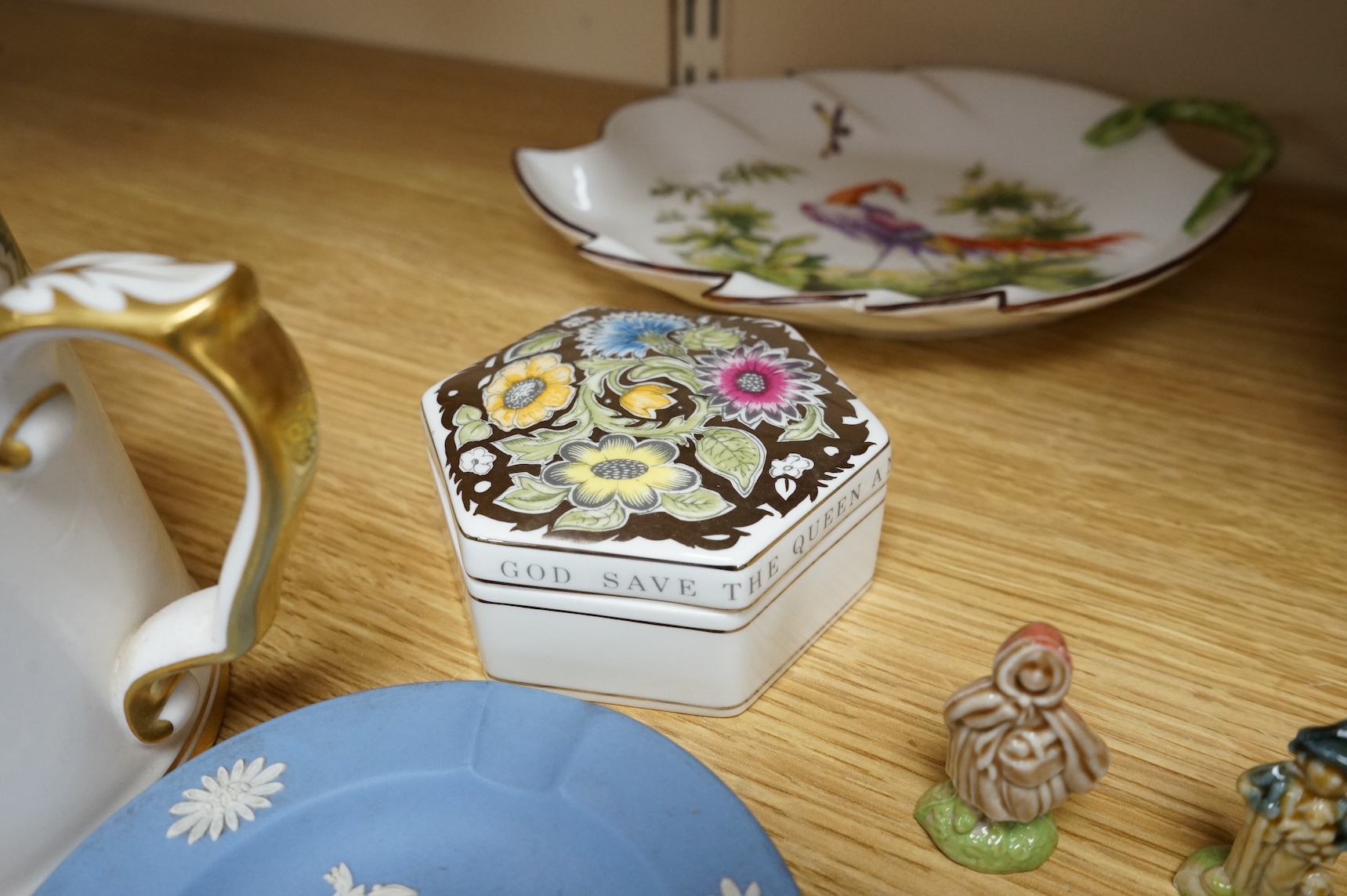 A collection of porcelain and pottery to include commemorative china, a leaf dish and group of wade figures, largest 29cm in diameter